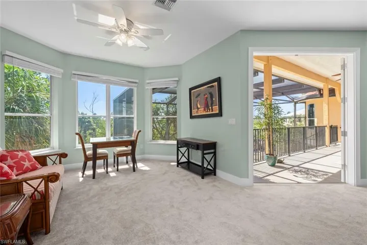 Light-filled interior space with a bay window and carpet flooring