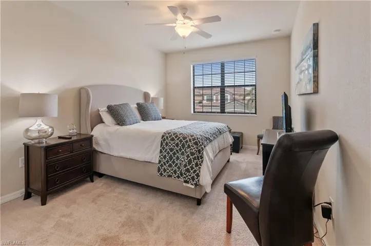 Carpeted bedroom with ceiling fan