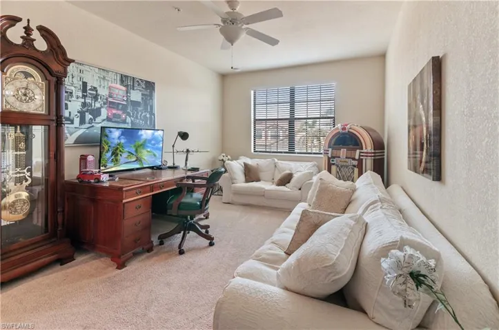Office area with light colored carpet and ceiling fan