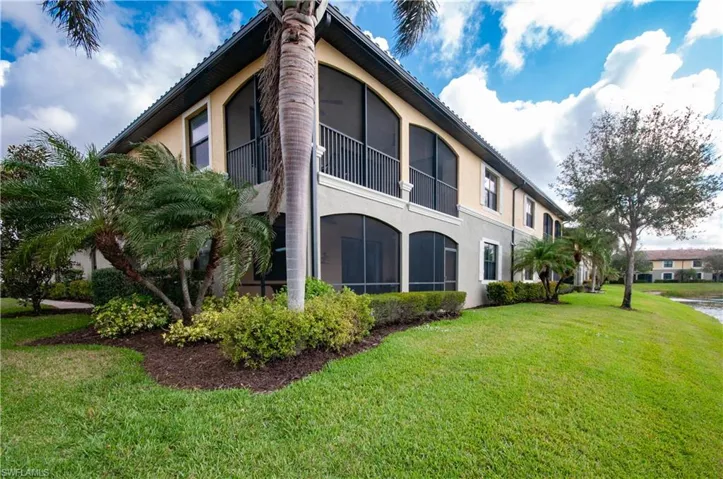 View of property exterior with a yard