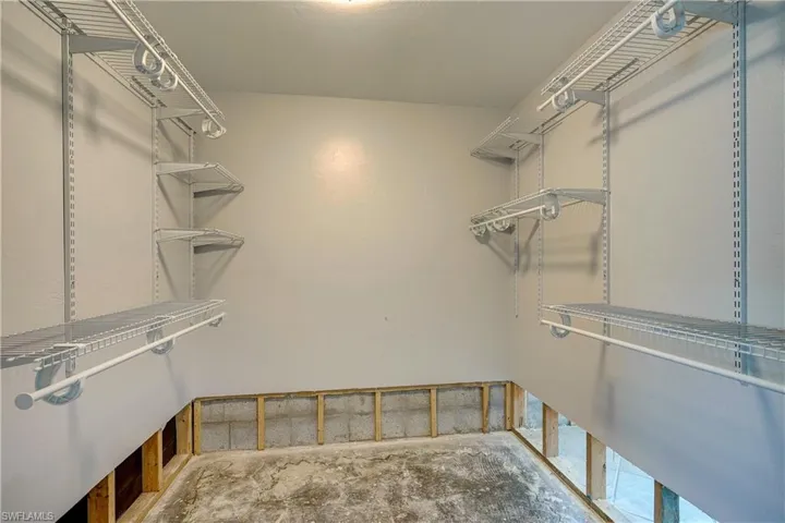 View of primary bedroom  walk in closet