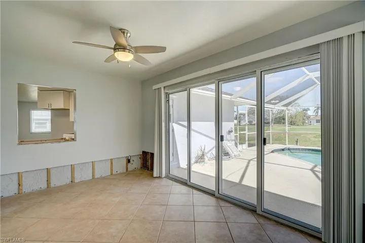 Den featuring light tile patterned floors, ceiling fan, and a healthy amount of sunlight