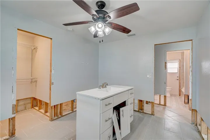 Bedroom with tiles and ceiling fan