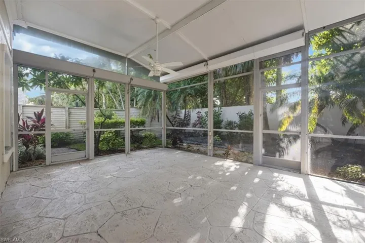 Unfurnished sunroom featuring ceiling fan and healthy amount of natural light