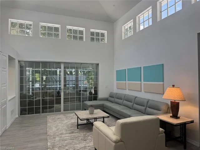 Living room with lofted ceiling and wood finished floors