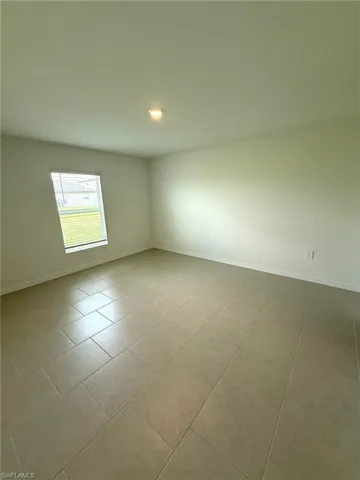 Tiled spare room with baseboards and recessed lighting