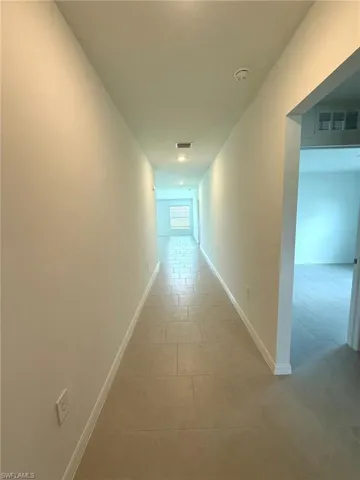 Hall featuring baseboards
