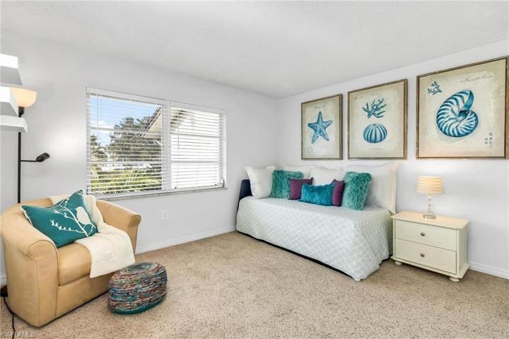 Guest bedroom set up with desk and day bed.