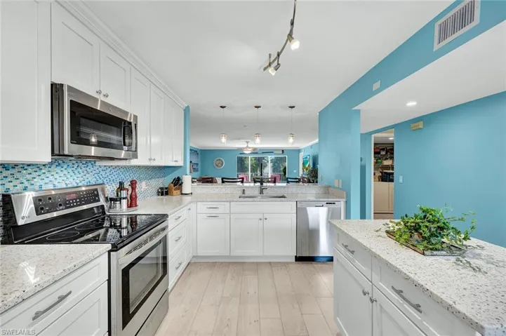 KITCHEN HAS BEEN REMASTERED TO INCLUDE SOFT-CLOSE SHAKER-STYLE CABINETRY, SEA GLASS INFUSED QUARTZ, NEWER APPLIANCES.