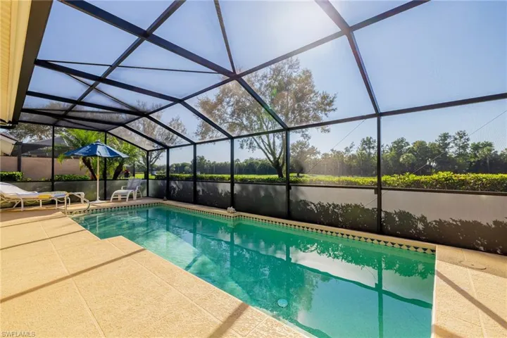 Outdoor pool featuring a lanai and a sunroom