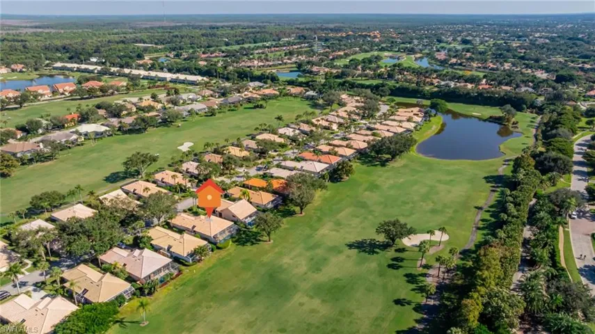 Aerial view of property's location featuring a large body of water and nearby suburban area