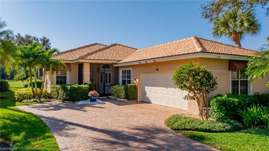 Mediterranean / spanish-style home featuring stucco siding, an attached garage, a tile roof, and decorative driveway