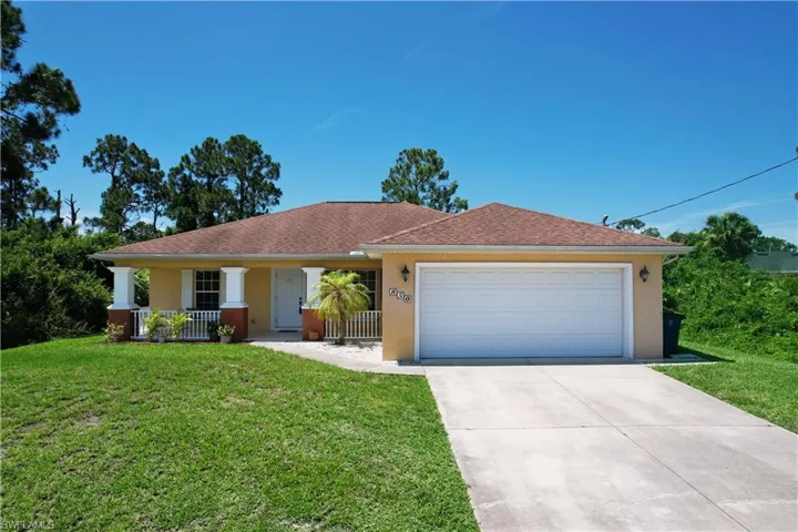 Ranch-style house with a garage and a front yard