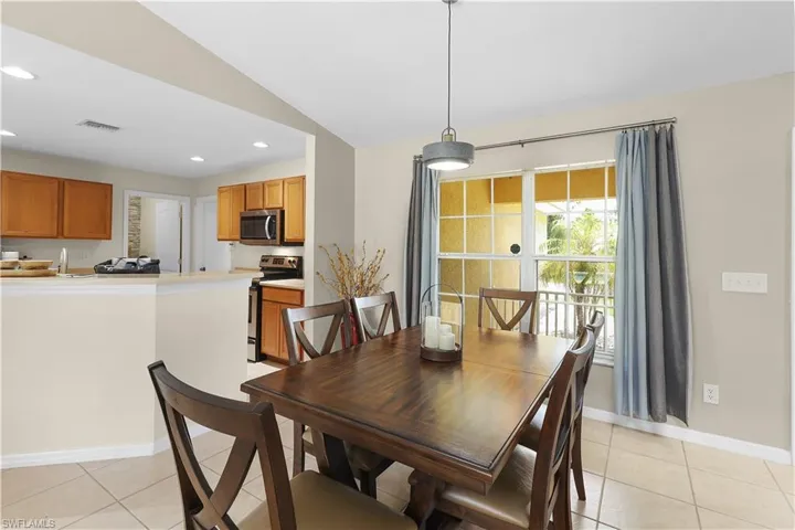 Tiled dining room with vaulted ceiling