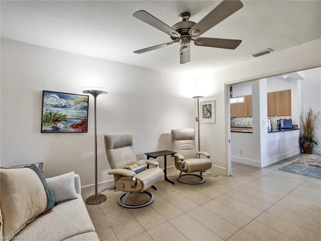 Sitting room featuring ceiling fan and light tile patterned floors