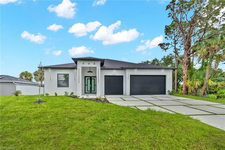 Contemporary single-story exterior with a contrasting dark roof and light façade