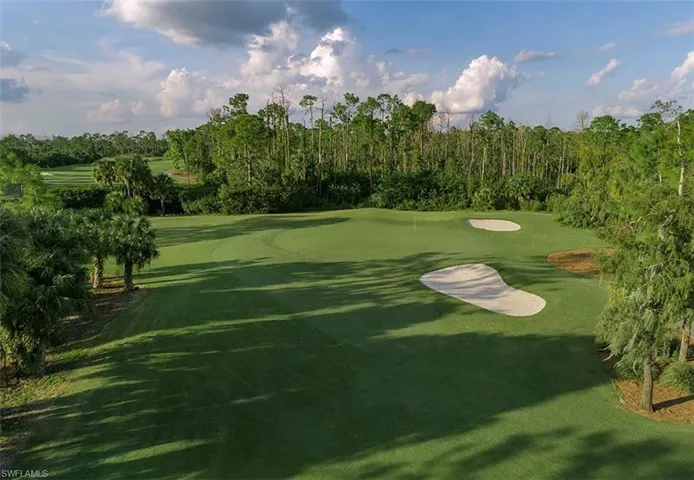 Surrounding community featuring golf course view and view of wooded area