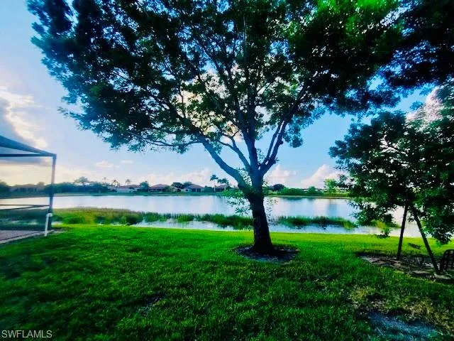 View of grassy yard with a water view
