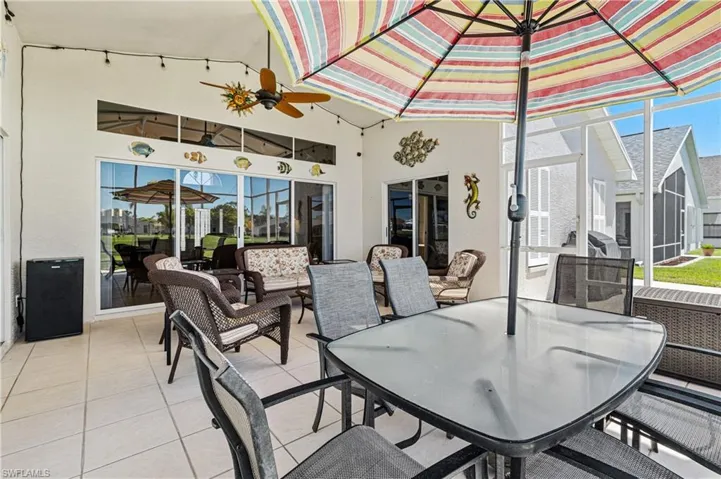 View of patio featuring outdoor dining space, a lanai, and an outdoor living space