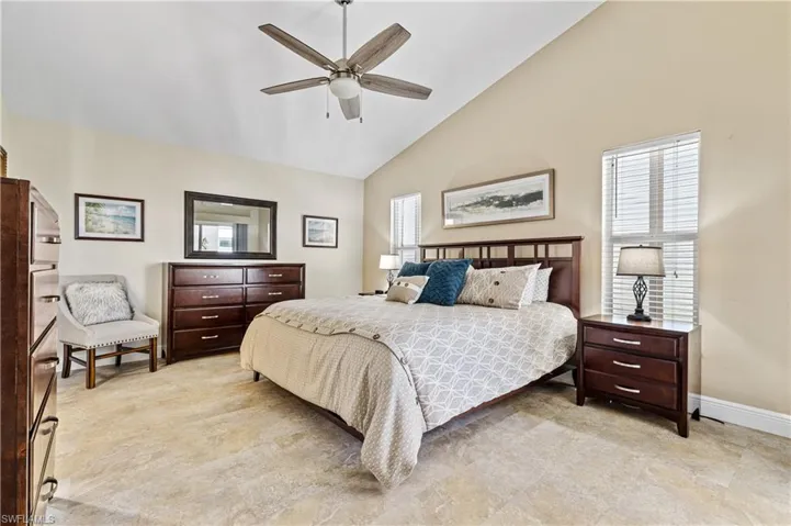 Bedroom featuring high vaulted ceiling, ceiling fan, and baseboards