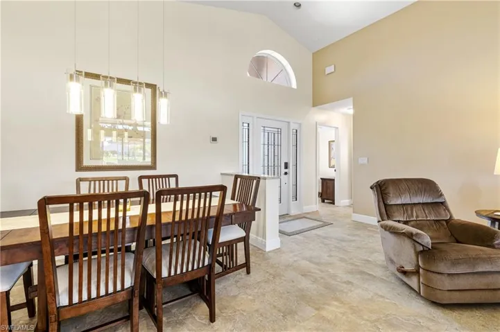 Dining room featuring high vaulted ceiling and baseboards