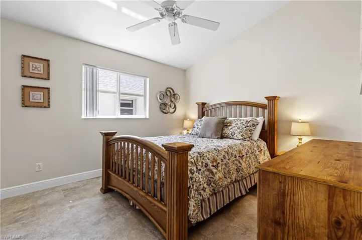 Bedroom featuring lofted ceiling, baseboards, and a ceiling fan