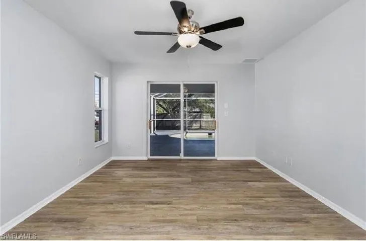 Empty room featuring a ceiling fan and wood finished floors