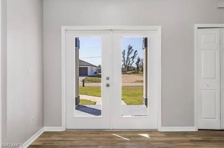 Doorway featuring french doors and wood finished floors