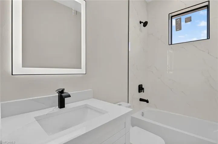 Guest bathroom with linin shelving storage area
