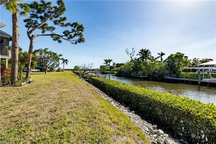 View of green lawn featuring a water view