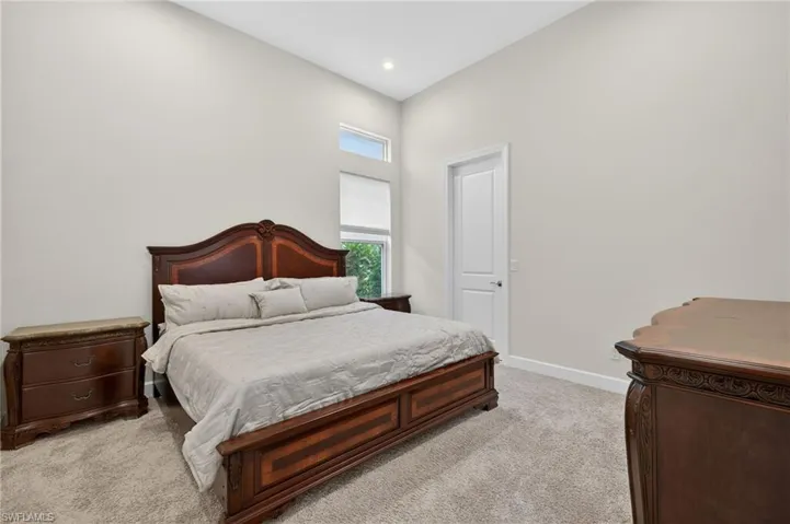 Bedroom featuring light colored carpet