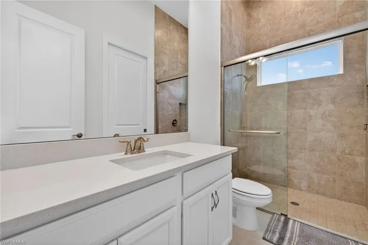 Bathroom with a stall shower and vanity