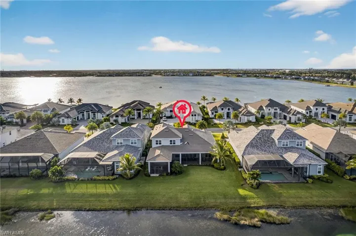 Aerial perspective of suburban area featuring a nearby body of water