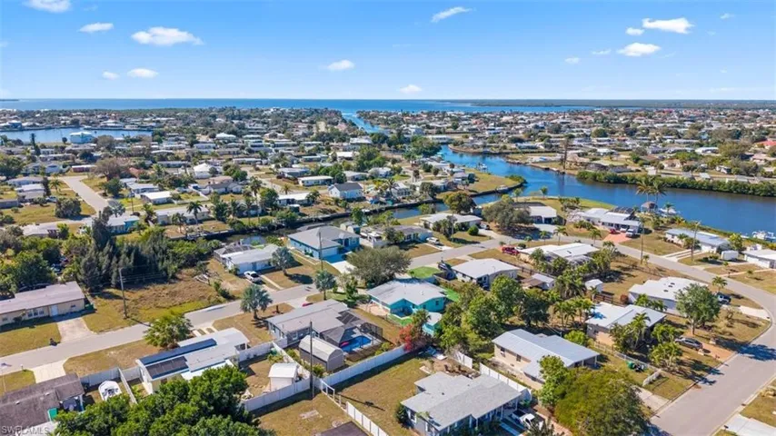 Aerial view of property's location featuring nearby suburban area and a nearby body of water