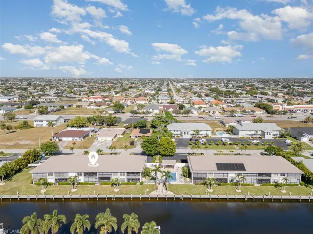 Aerial view of residential area featuring a large body of water