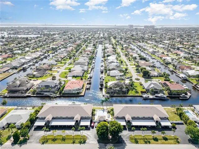 Aerial perspective of suburban area featuring a nearby body of water