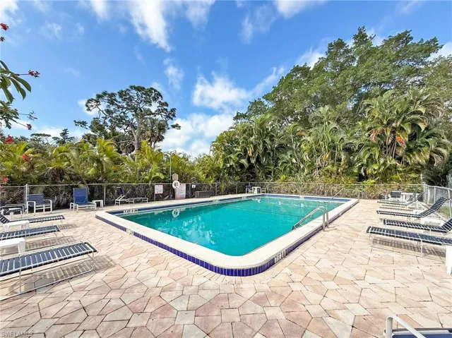 Pool with fence and a patio area