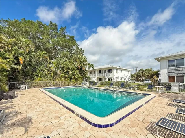 Pool featuring a patio area and fence