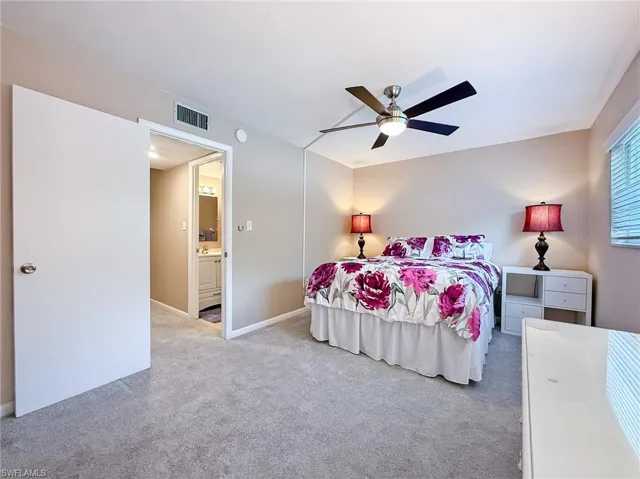 Bedroom featuring carpet floors, baseboards, ceiling fan, and visible vents