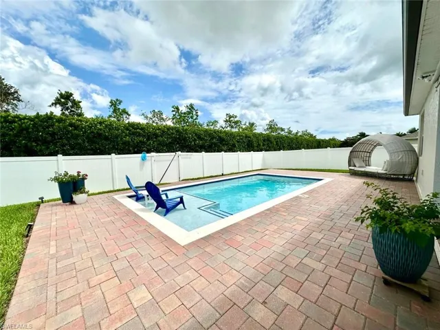 View of pool with a patio and a fenced backyard