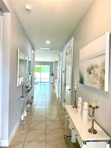 Hallway featuring light tile patterned flooring and recessed lighting
