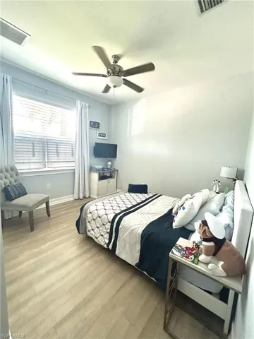 Bedroom with wood finished floors and ceiling fan