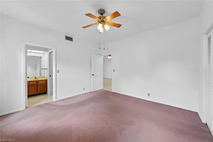 bedroom featuring ceiling fan, a closet, and carpet flooring