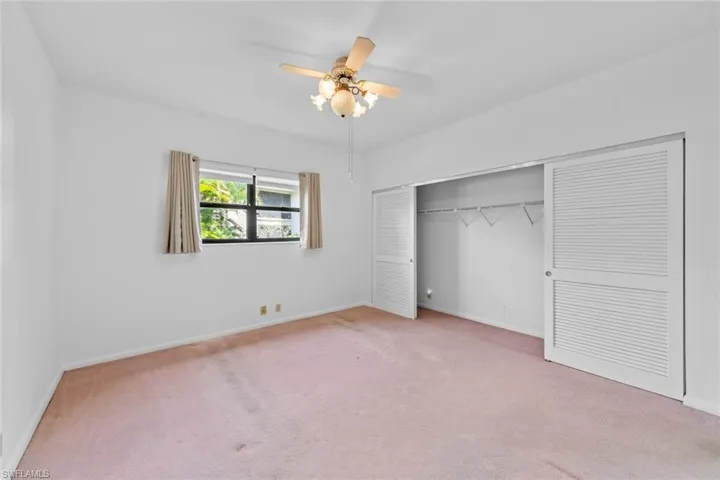 bedroom with carpet, ceiling fan, and a closet