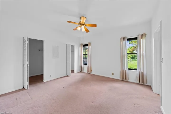 bedroom with walk-in closet and ceiling fan
