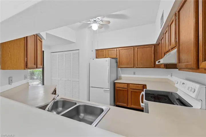 Kitchen with ceiling fan, appliances, and sink
