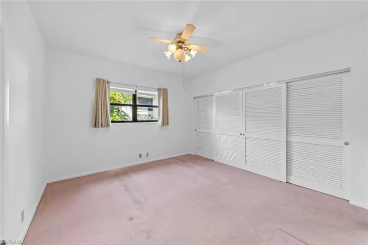 bedroom with carpet, ceiling fan, and a closet