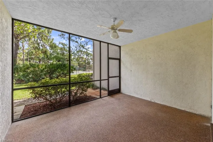 Lanai featuring ceiling fan with view to tennis courts and landscaping