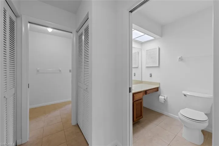 Bathroom with vanity, toilet, and tile floors