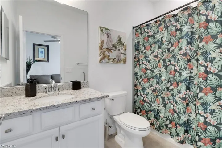 Bathroom with vanity and curtained shower
